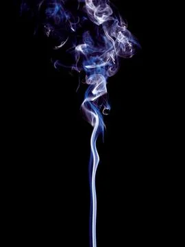 A thin stream of white and blue smoke swirls and gently rises up Stock Photos