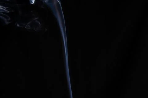 A thin stream of white smoke on a dark background with place for text, no peo Stock Photos