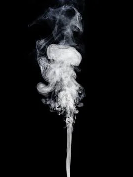 A thin stream of white smoke rises and creates swirls against the black Stock Photos
