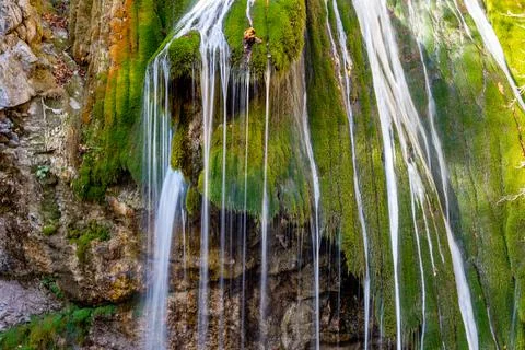 Thin streams of a mountain waterfall. Stock Photos