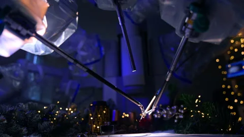 Thin tiny forceps of robotic arms managing the writing pen to write a letter.  Stock Footage 221113083