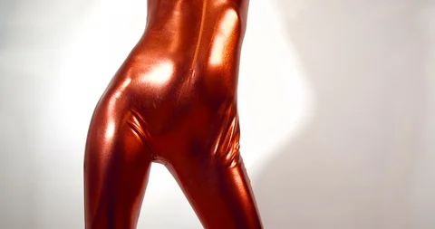 Thin unrecognizable girl in a tight  fitting shiny red zentai suit 動画素材 124466375
