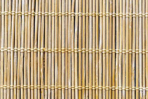 Thin, vertical bamboo sticks bound together by horizontal thread Stock Photos