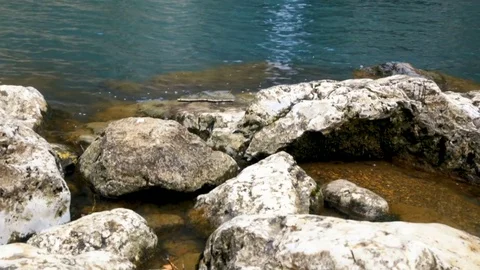 Thin waterfall between rocks and lake 스톡 동영상 85237897