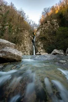 Thin waterfall in the mountains in the forest, waterfall and stones Stock Photos