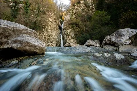 Thin waterfall in the mountains in the forest, waterfall and stones Stock Photos