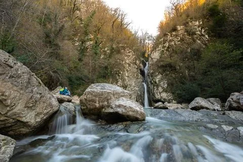Thin waterfall in the mountains in the forest, waterfall and stones Stock Photos
