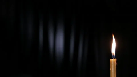 Thin wax candle burning on a black background with white beam, Fixated. Stock Footage 46952576