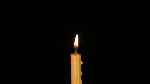 Thin wax candle burning on a black background. Under the alpha channel. Stock Footage 46953781