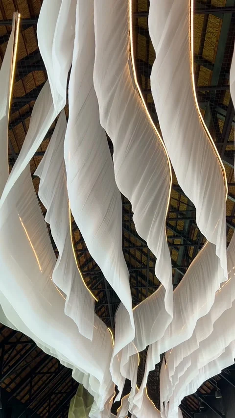 Thin white fabrics flutter in the gentle breeze from the ceiling. Decor elements Stock Footage 318973533
