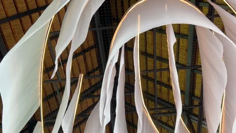 Thin white fabrics flutter in the gentle breeze from the ceiling. Decor elements 動画素材 318973635