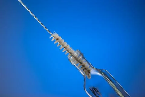 Thin wire brush for cleaning bottles. Inside small empty glass bottle. Close  스톡 사진