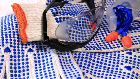 Thin work gloves with  blue pimples, protective glasses and ear plugs Video stock 70826192