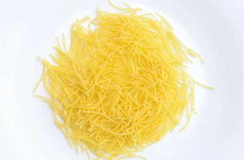 Thin yellow mackerons on a white plate. Stock Photos