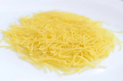 Thin yellow mackerons on a white plate. Stock Photos