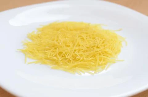 Thin yellow mackerons on a white plate. Stock Photos