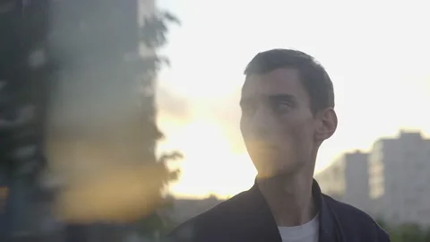 A thin young guy stands at sunset Stockbeeldmateriaal 156001986
