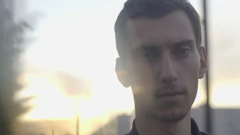 A thin young guy stands at sunset 스톡 동영상 156002021