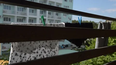 Things are dried on a rope on the balcony in summer. background for decoration Stock Footage 279737619