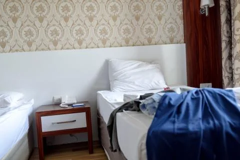 Things are scattered randomly on the hotel bed, Stock Photos
