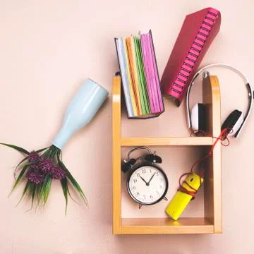 Things fall from the shelves due to the fact that the headphones play music. Stock Photos