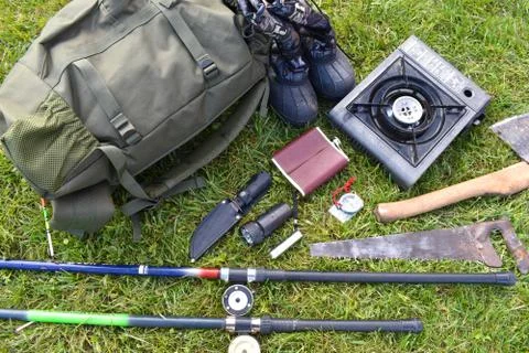 Things hunter on the grass. A necessary set of items for natural extreme travel. Stock Photos