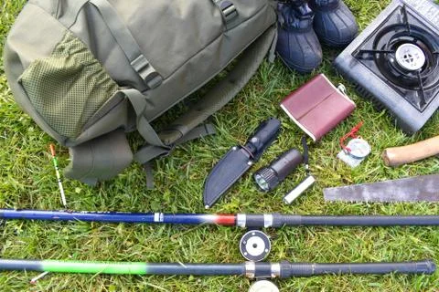 Things hunter on the grass. A necessary set of items for natural extreme travel. Stock Photos