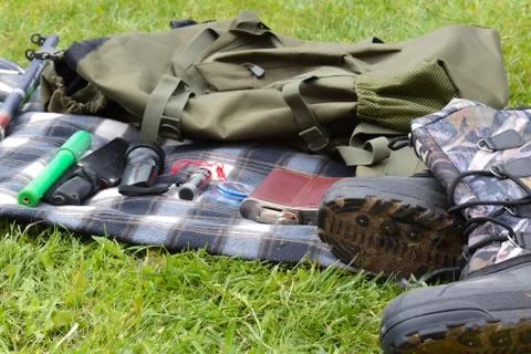 Things hunter on the grass. A necessary set of items for natural extreme travel. Stock Photos