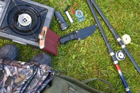 Things hunter on the grass. A necessary set of items for natural extreme travel. Stock Photos