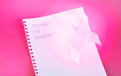 Things to know is written in Notepad with pink ribbon awareness breast cancer Stock Photos