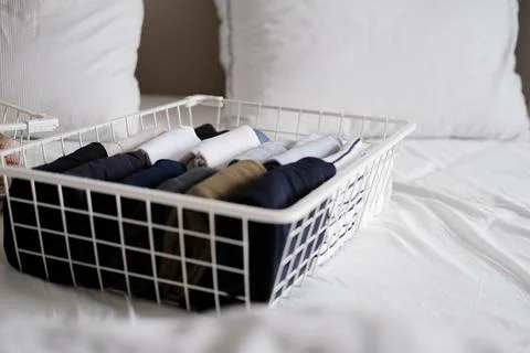 Things in mesh storage containers. Vertical storage of clothing. Sorting clothes Stock Photos