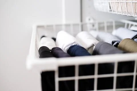 Things in mesh storage containers. Vertical storage of clothing. Sorting clothes Stock Photos
