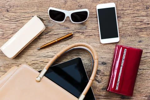 Things pulled out of handbag put on a table Stock Photos