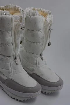 Things, winter women's boots with silver snowflakes, gray leather inserts. Stock Photos