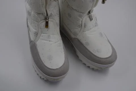 Things, winter women's boots with silver snowflakes, gray leather inserts. Stock Photos