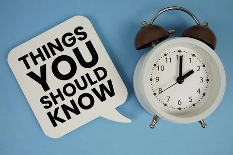 Things You Should Know text with alarm clock on blue background Stock Photos