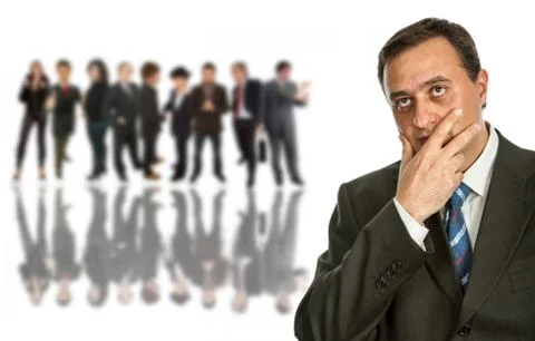 Thining, young pensive business man in front of a group of people Foto stock