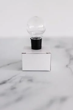 Think outside the box concept with idea lightbulb on top of white box on whit Foto stock