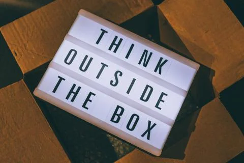 Think outside the box message on lightbox on top of open parcel Stock Photos