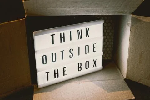 Think outside the box message on lightbox with parcel, 写真素材