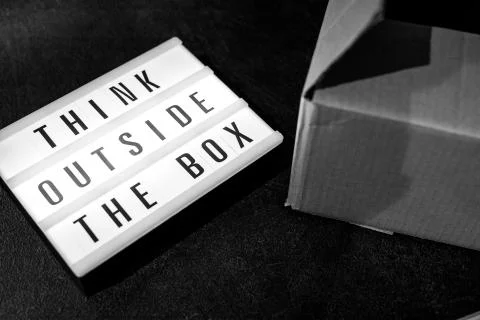 Think outside the box message on lightbox on top of open parcel Stock Photos