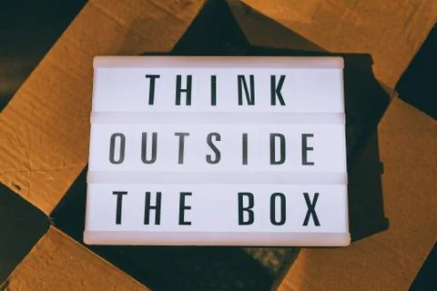Think outside the box message on lightbox on top of open parcel Stock Photos