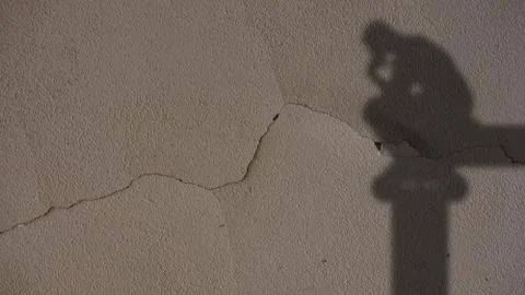 Thinker Shadow on Grey Cracked Wall Stock Photos
