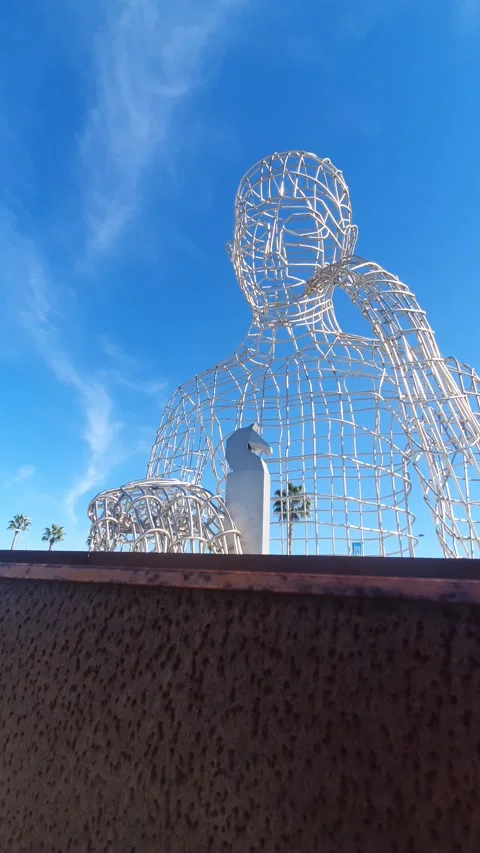 The thinker's monument with a chess piece in Dos Hermanas with palm trees Stock Footage 224869564