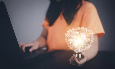 Thinking and creative concept, Asian girl holding the light bulb  in graph Sc Stock Photos