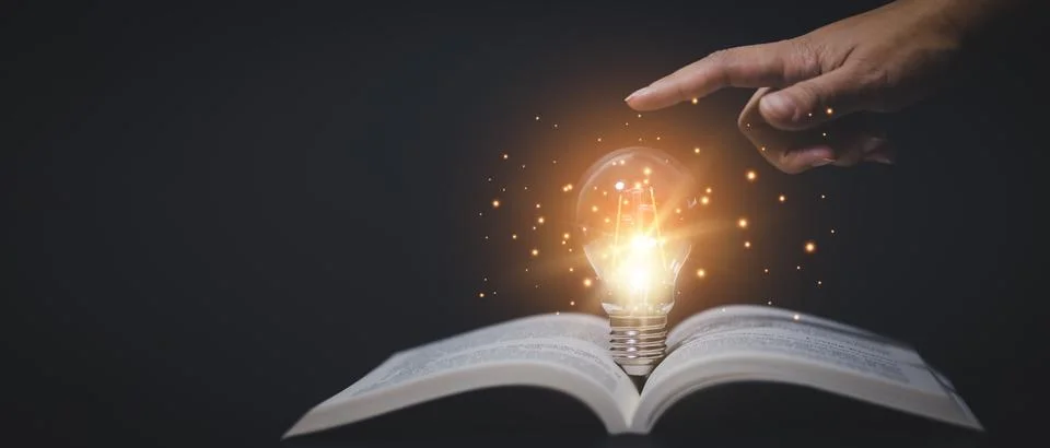 Thinking and creative concept, Hand touch Light bulb on the Book and light bu Stock Photos