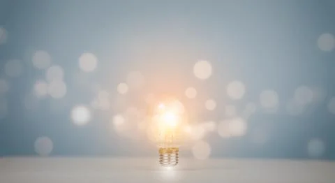 Thinking and creative concept,Light bulb with line bokeh on the wooden table, Stock Photos