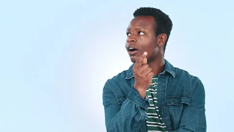 Thinking, black man and ideas with doubt, pointing and problem solving on a blue Stock Footage 251774687