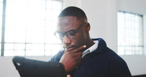 Thinking, black man and reading in office with tablet, research and pricing for Stock Photos