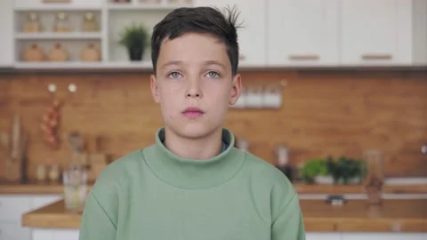 Thinking boy looking up and around at home interior. Worried contemplative face Stock Footage 140001915